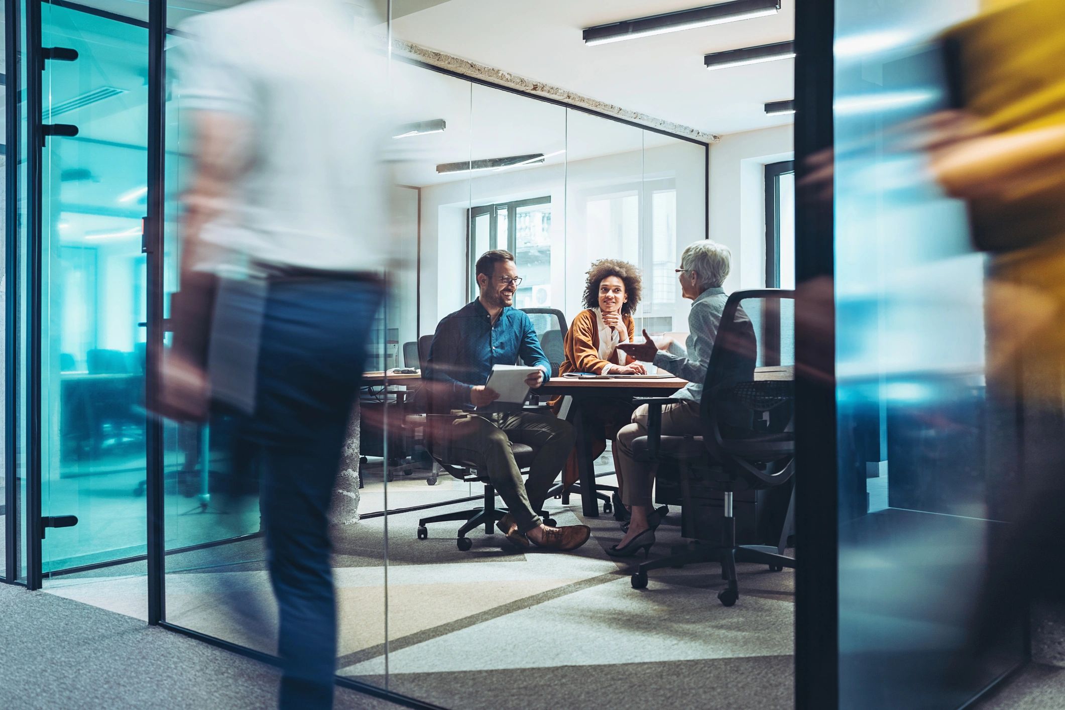 Team meeting in a modern glass conference room