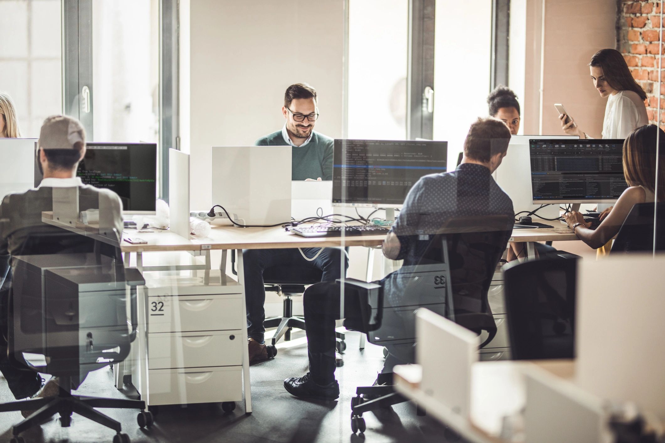 Software engineers collaborating in an office, representing cross-functional execution