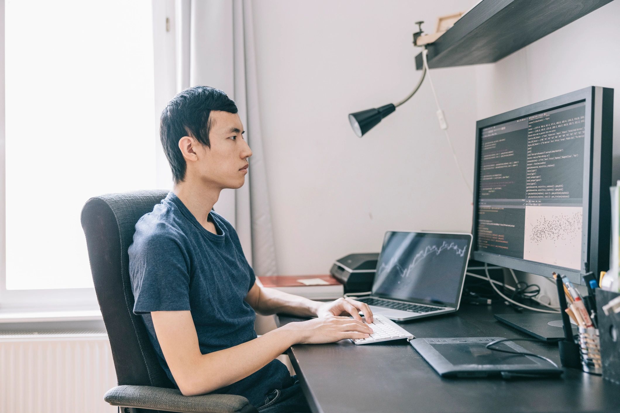 Engineer reviewing system metrics on a laptop